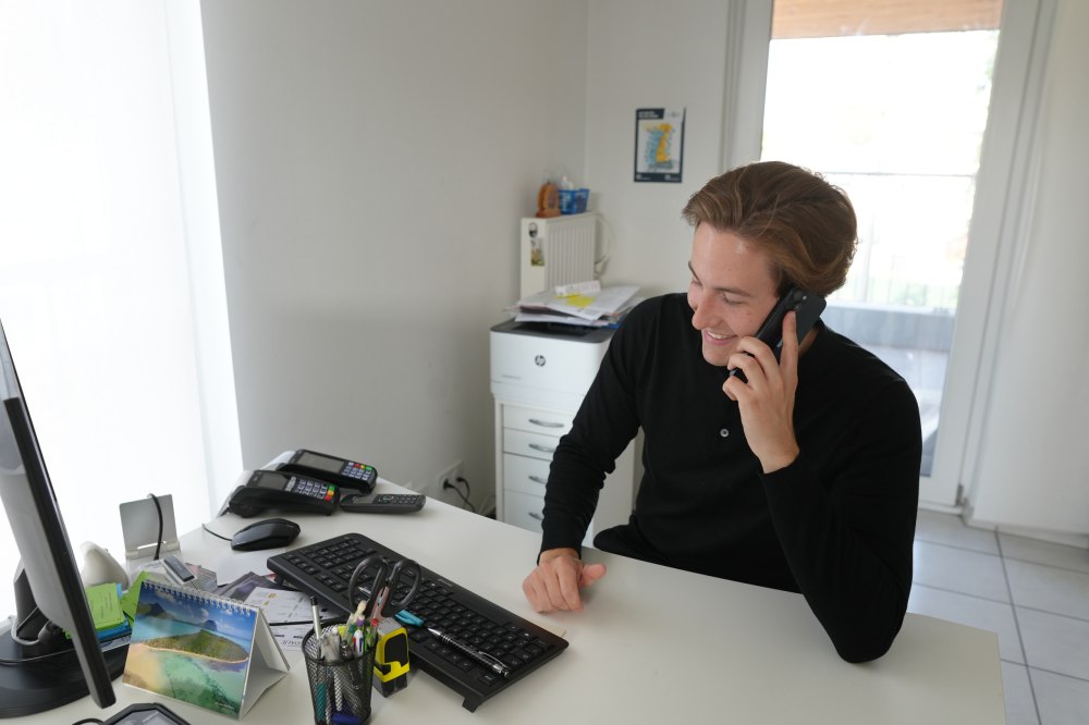 Sanovetis-Berater im Telefongespräch an seinem Arbeitsplatz