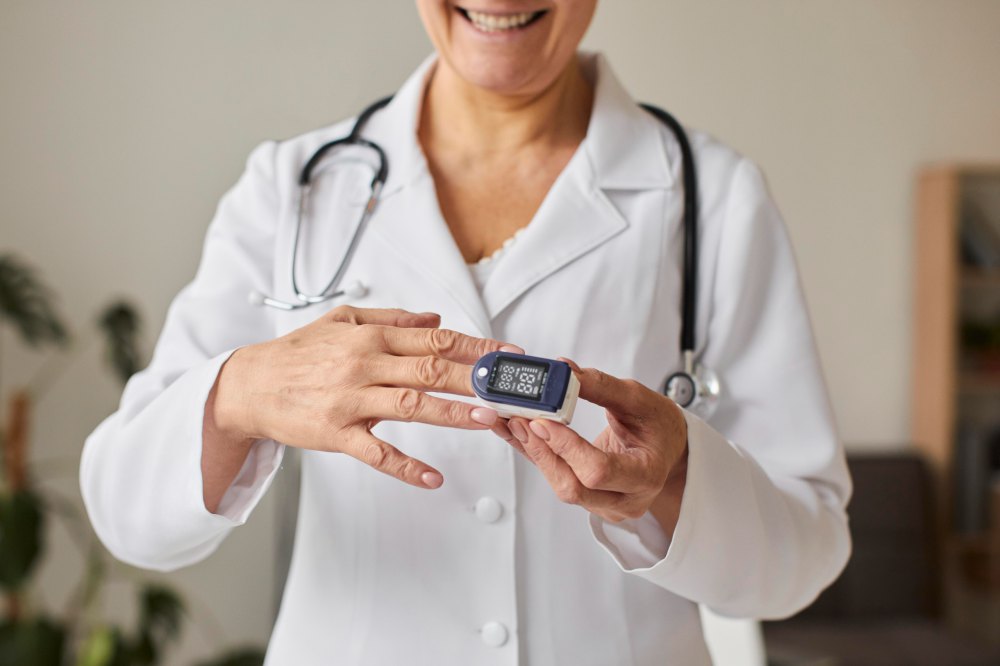 Ärztin misst bei einem Patienten die Sauerstoffsättigung