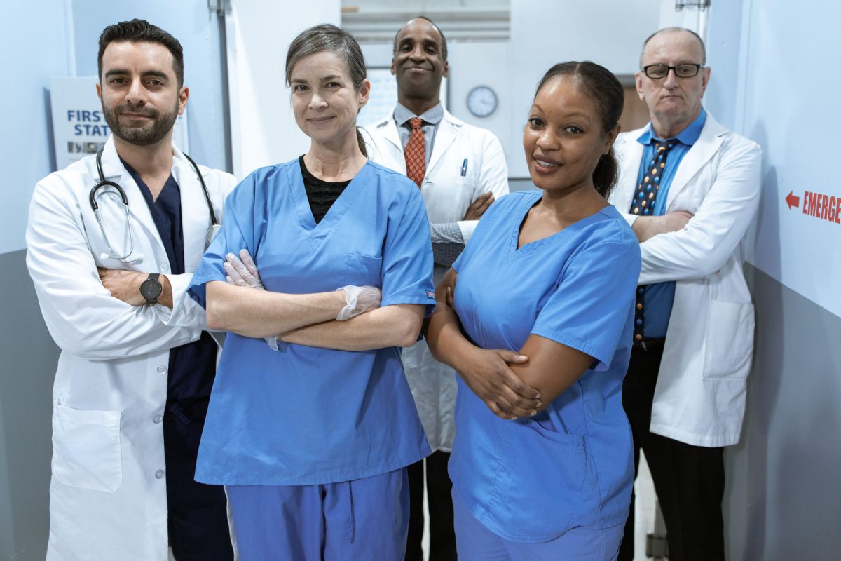 Ärztinnen, Ärzte und Pflegekräfte einer Klinik im Gespräch